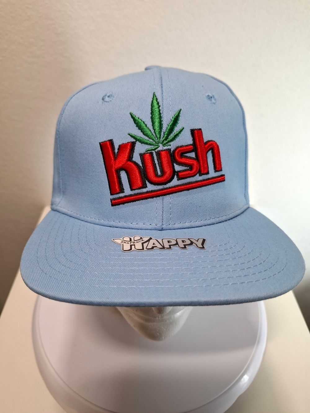 Kush Embroidered Light Blue Snapback Hat with Green Leaf Accent